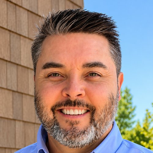 Rob Warfield, founder of ReviiewCo, smiling outside in a blue button down shirt